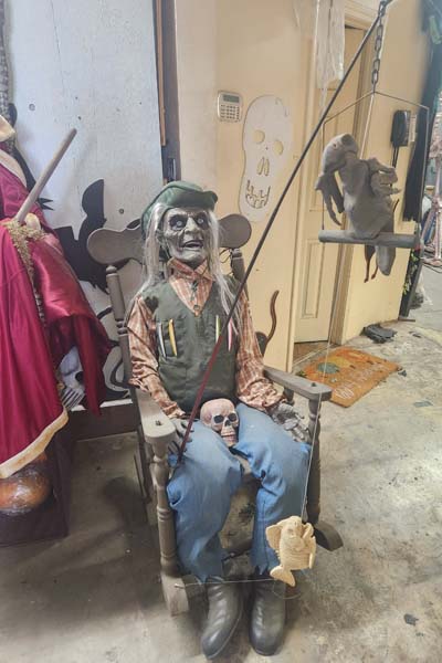 Sitting fisherman with skeleton bird