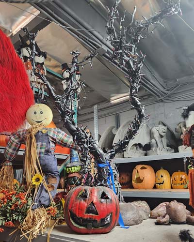 Lighted burnt bush growing out of a jack-o-lantern